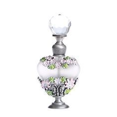 a white glass vase with flowers and leaves on the top is sitting in front of a white background