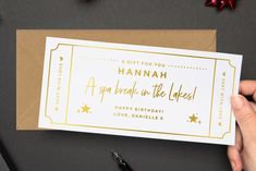 a hand holding up a birthday card with the words hannah on it and stars around it