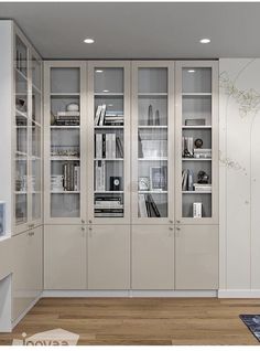 an empty room with glass doors and bookshelves on the wall in front of it