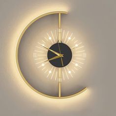 a clock that is on the wall with light coming from it's face and hands