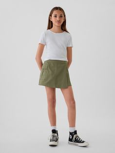 Smooth woven cotton-Tencel blend skort.  E-waist at back, concealed hook and bar closure at front.  Cargo pocket.  Inner shorts, wrap-style front.  This product was made in a factory that invests in gender equality and women’s empowerment.  Through RISE Reimagining Industry to Support Equality) and Gap Inc. ’s program P. A. C. E.  Personal Advancement & Career Enhancement), we support people who make our clothes to build the skills, knowledge, confidence, and resilience needed to advance in work Cotton School Shorts With Pockets, School Cotton Shorts With Pockets, Cotton Mini Skort With Side Pockets, Mini Skort With Side Pockets In Cotton, Fitted Cotton Shorts By Gap, Gap Fitted Cotton Shorts, Casual Cotton Skort With Cargo Pockets, Casual Cotton Skort With Side Pockets, Spring School Shorts With Pockets