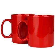 two red coffee mugs sitting next to each other