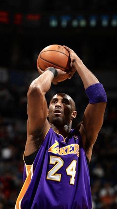 the basketball player is getting ready to dunk the ball in his hand while holding it up