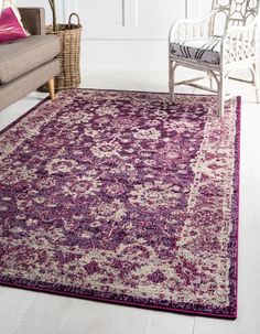 a living room with a purple rug on the floor and a chair in front of it