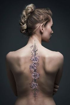 the back of a woman's body with flowers on her upper and lower back