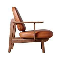 a brown leather chair sitting on top of a wooden frame