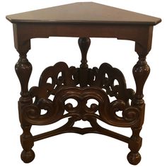 an old wooden table with ornate carvings on the top and bottom, against a white background