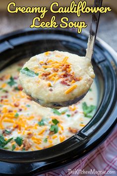 a spoonful of creamy cauliflower leek soup in a crock pot