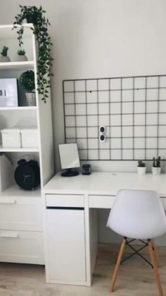 a white desk with two chairs next to it and a book shelf on the wall