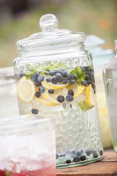 mason jars filled with lemons, blueberries and water