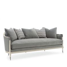 a gray couch with many pillows on it