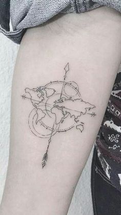 a woman's arm with a tattoo on it and a world map in the middle