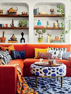 a living room filled with lots of furniture and decor