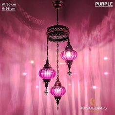 three pink lamps hanging from a ceiling in front of a curtained background with the words purple on it