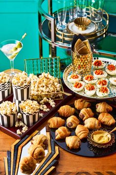 a table topped with lots of food and desserts