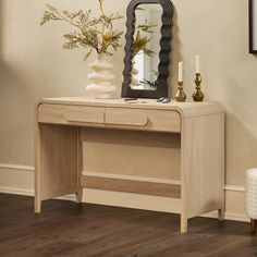 a wooden desk with a mirror and vase on it