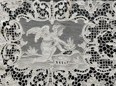 white lace with an image of a woman holding a bird on it's back