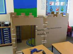 a cardboard castle sitting in the middle of a classroom