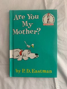 the book are you my mother? by p d eastman is laying on a bed