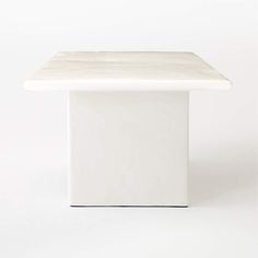 a white square table on a white background with no one around it or someone else