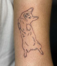 a small dog tattoo on the arm