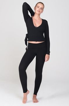 ~Black~ This soft, thermal wrap sweater is as stunning as it is versatile!It's beautiful as a yoga coverup, and looks great paired with a tee and jeans for a casual, effortless style. 96% Pima Cotton, 4% Poly. Made in USA. Pre-washed extra soft. Length: 27"Colors: Natural, Black, Peachy Pink Model is 5'9," size 2, and wearing a size small. Shown with the Sueded Foldover Hatha Legging Pink Model, Black Model, Wrap Sweater, Peachy Pink, Wrap Top, Pima Cotton, Effortless Style, Looks Great, Made In Usa