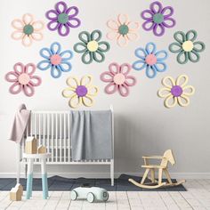 a baby's room with flowers on the wall and toys in the foreground