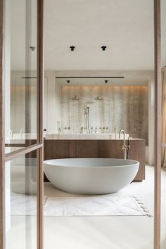 a large white bath tub sitting inside of a bathroom