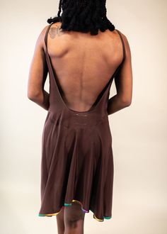 the back of a woman wearing a brown dress