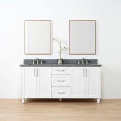 two mirrors are above the double sinks in this white bathroom with wood floors and wooden flooring