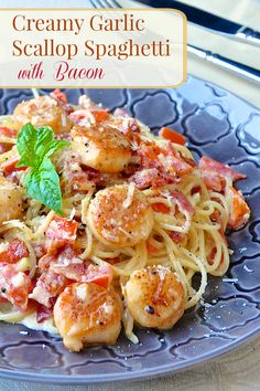 a blue plate topped with pasta and shrimp