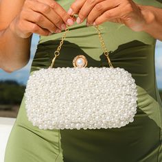 The Chantal Pearl Clutch Bag is a bag that will add a sense of sophistication and glamor to your appearance. You can carry it with elegance and style to your next formal event. Its simple yet luxurious design will surely turn all heads! Exclusively available in white. Formal White Bags With Pearl Handle, Chic White Party Bags, Chic White Bags With Pearl Handle, White Pouch Bag For Party, Chic Handheld Shoulder Bag For Events, White Shoulder Bag For Wedding, White Shoulder Evening Bag For Weddings, White Shoulder Evening Bag For Wedding, White Box Bag With Detachable Handle For Party