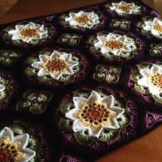 there is a crocheted blanket with flowers on it