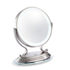 a small round mirror on a stand with a light up base and an illuminated backlight