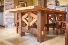 a wooden table sitting on top of a tiled floor