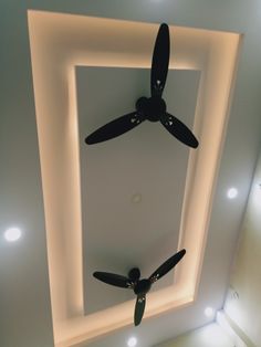 a ceiling fan mounted to the side of a wall in a room with white lights