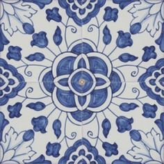 a blue and white tile with an intricate design