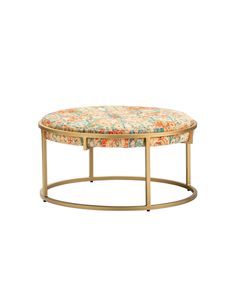 a round ottoman with floral upholstered fabric on the top and gold metal frame