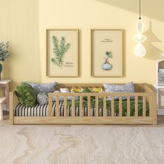 a baby's room with two framed pictures on the wall and a wooden crib