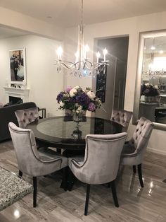 a dining room table with chairs and a chandelier