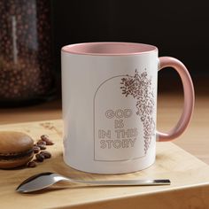 a pink and white coffee mug with the words god is in this story on it