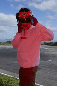 a person wearing a helmet and holding a cell phone up to their face