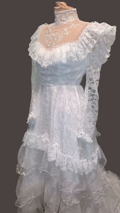 a white dress with ruffles and lace on it