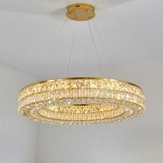 a chandelier hanging from the ceiling in a room with white walls and flooring