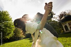 a bride and groom kissing in the sun