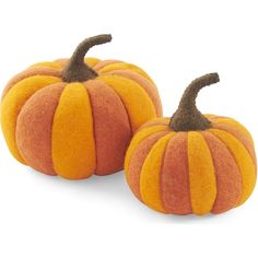 two orange pumpkins sitting next to each other