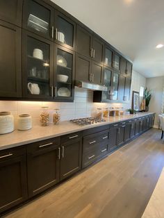 a kitchen with black cabinets and white counter tops