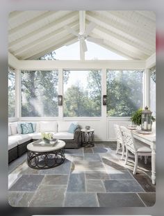 a living room filled with furniture and lots of windows