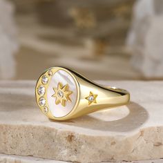 The crescent moon and star is one of our world's most ancient symbols, combining powerful icons joining man and woman. The star represents the female principle, and celebrates the cosmic powers of the love Goddesses Venus. This signet ring captivates us with its sparkling diamond and gold tone details. We love that it is bursting with celestial wonder!Carat Weight: 0.544 ctStone Size: 1.3,1.5,1.7,2.1,2.5 mmStone Type: Jeulia® StoneNumber of Stones: 9 Stone Shape: RoundStone Color: Diamond WhiteW Celestial Star Jewelry, Celestial Open Ring Jewelry, Symbolic Sun And Moon Star Jewelry, Mystical Moon Phase Ring, Moon Phase Rings As Gifts, Moon Phase Open Ring, Cosmic Powers, Crescent Moon And Star, Mountain Ring