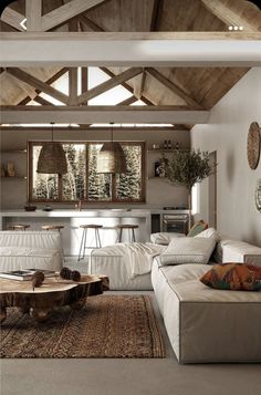 a living room filled with lots of furniture and wooden beams on top of the ceiling